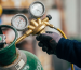 industrial brass gas regulator with pressure gauges connected to LPG cylinder for gas system control